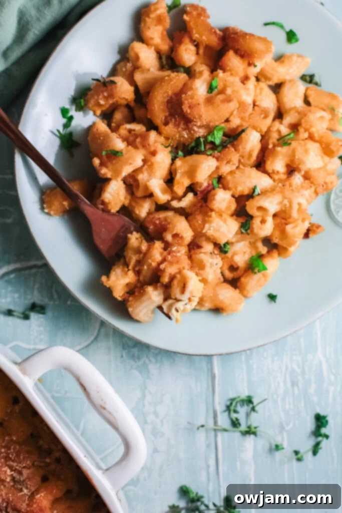 Creamy Pumpkin Mac and Cheese 2 Creamy Pumpkin Mac and Cheese on a teal plate, ready to be enjoyed as a fall comfort meal.