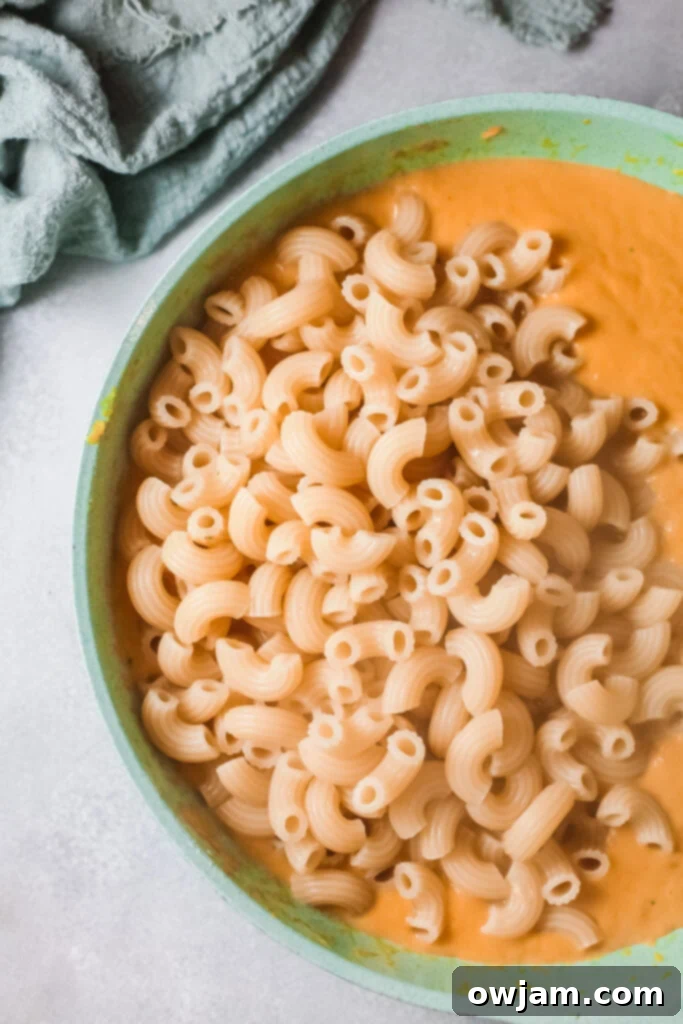 Creamy Pumpkin Mac and Cheese 6 Creamy pumpkin cheese sauce in a pan, smooth and ready for pasta.