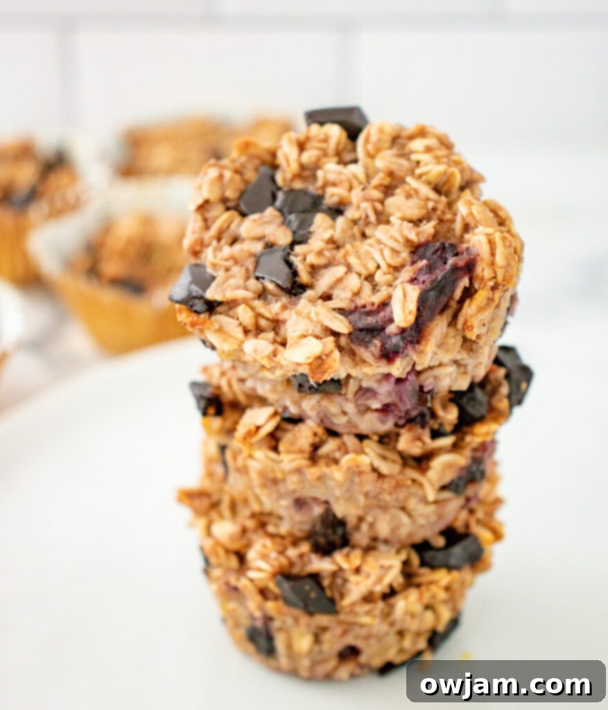 Wholesome Banana Oat Wonders 5 A stack of golden brown Banana Oatmeal Muffins, showcasing their fluffy texture.