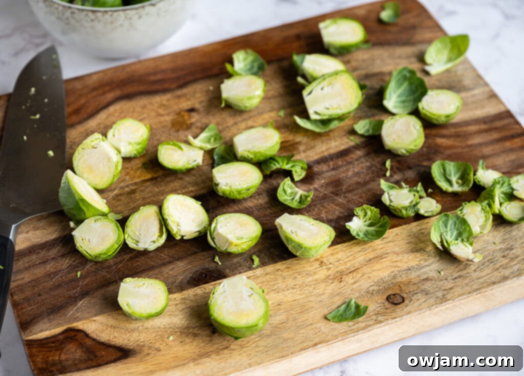 Caramelized Balsamic Brussels Sprouts 4 Prepped Brussels sprouts, trimmed and halved, ready for roasting on a cutting board.
