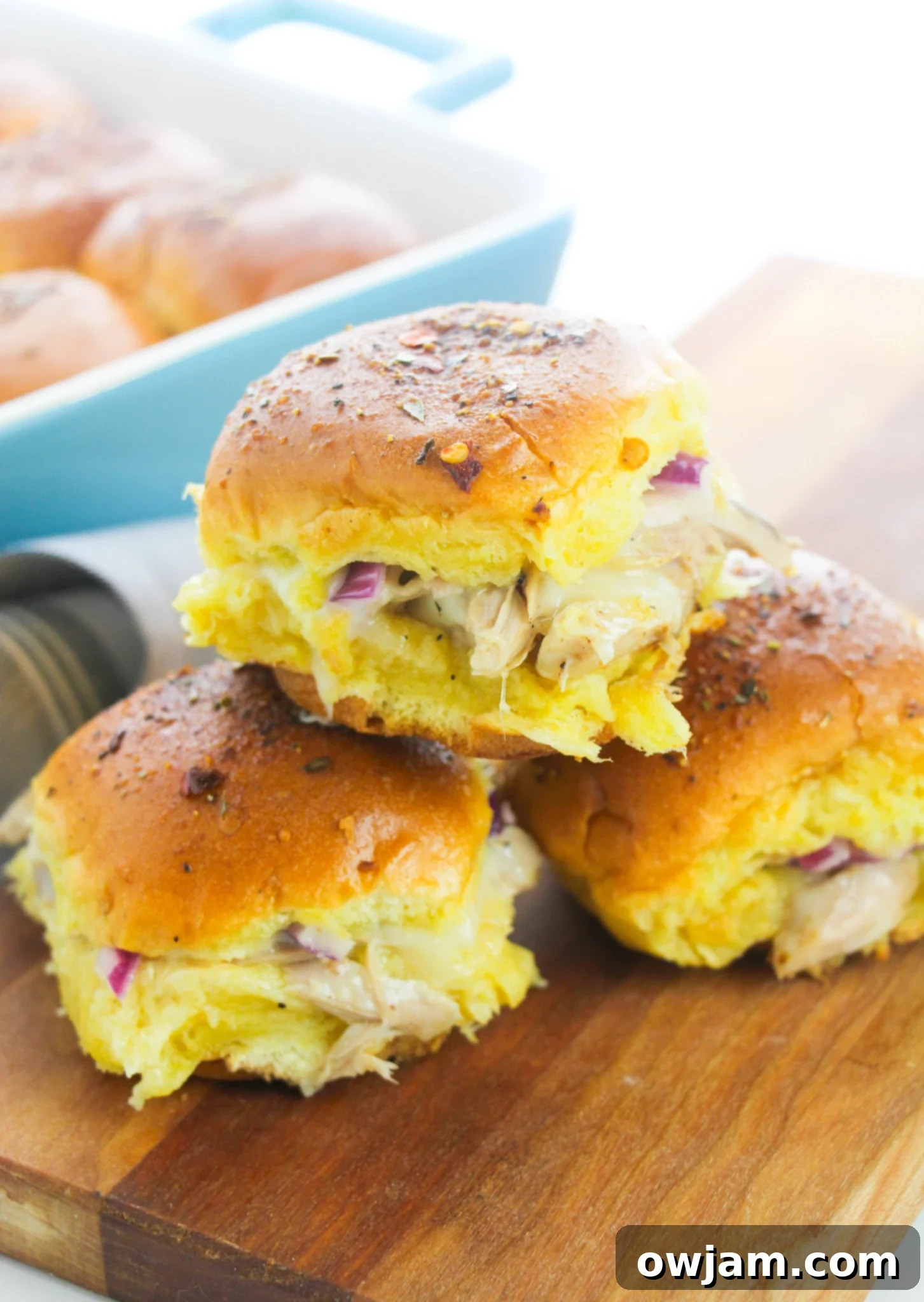 Easy Chicken Sliders stacked on top of each other, showcasing their delicious layers