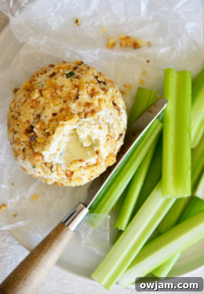 Whip Up a Crowd-Pleasing Cheese Ball 5 Finished cheese ball on a white plate ready to serve