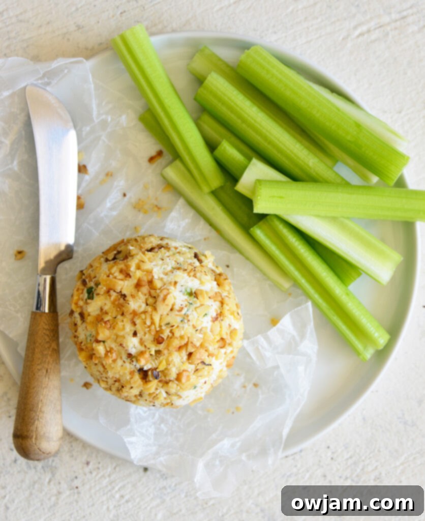 Whip Up a Crowd-Pleasing Cheese Ball 9 Two cheese balls on a white plate with crackers and celery