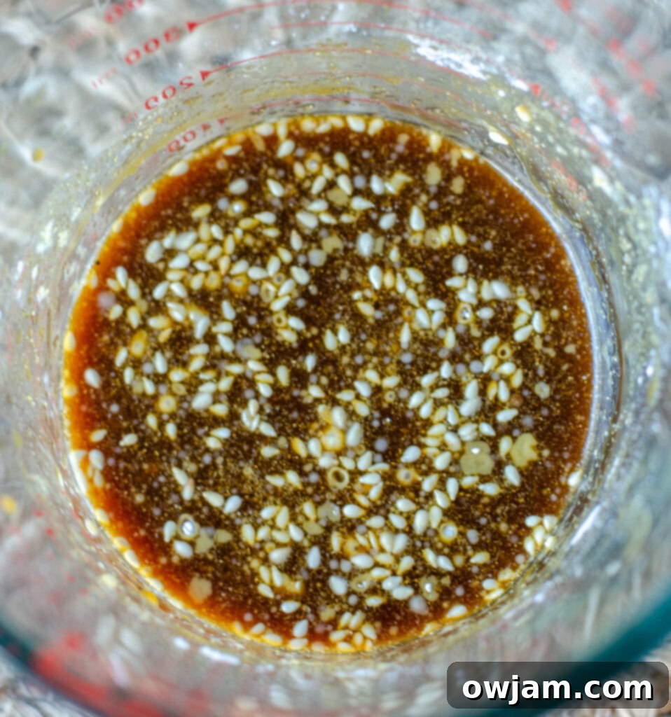 Homemade teriyaki sauce mixture in a clear bowl, ready to be poured over salmon