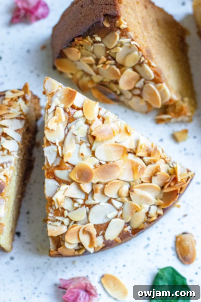 Irresistible Almond Cake 4 A perfectly baked slice of Honey Almond Cake, showcasing its moist interior and beautiful golden crust, ready to be enjoyed