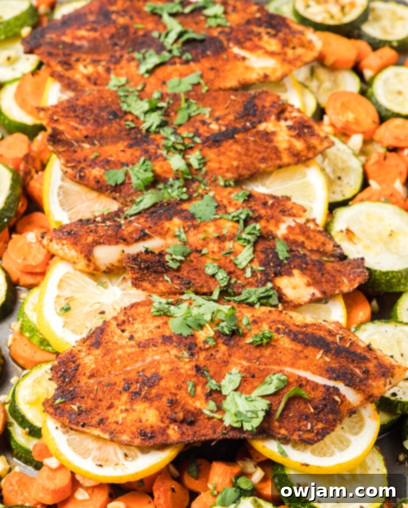 Easy Blackened Fish on tray with lemon slices and vegetables