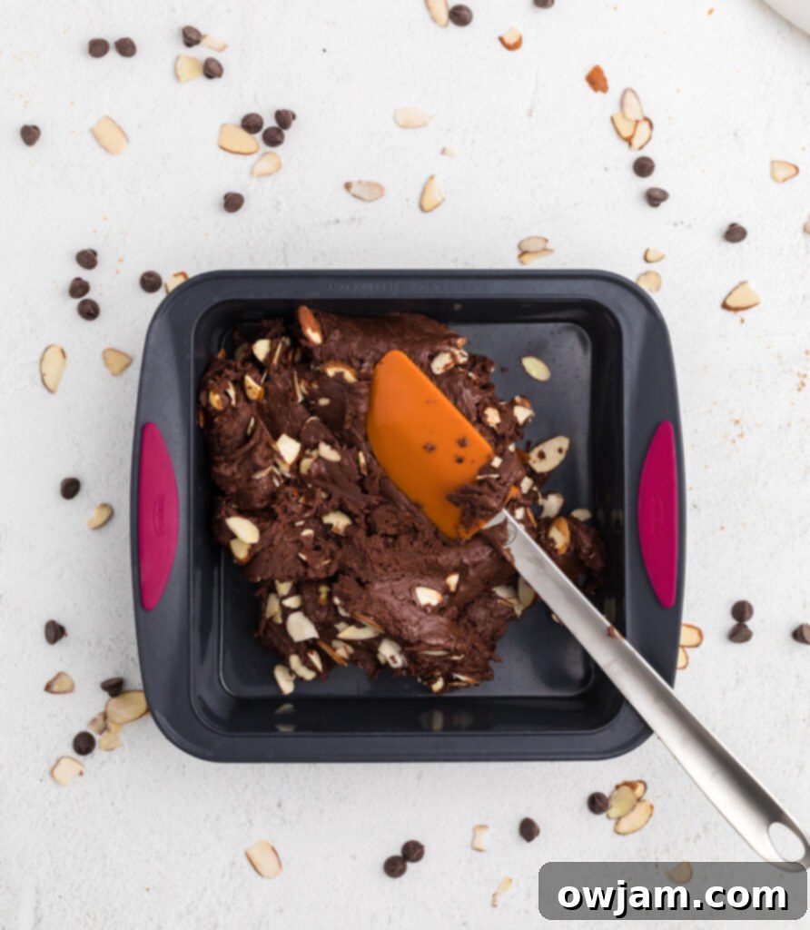 Easy Chocolate Fudge mixture poured into a square pan to set.