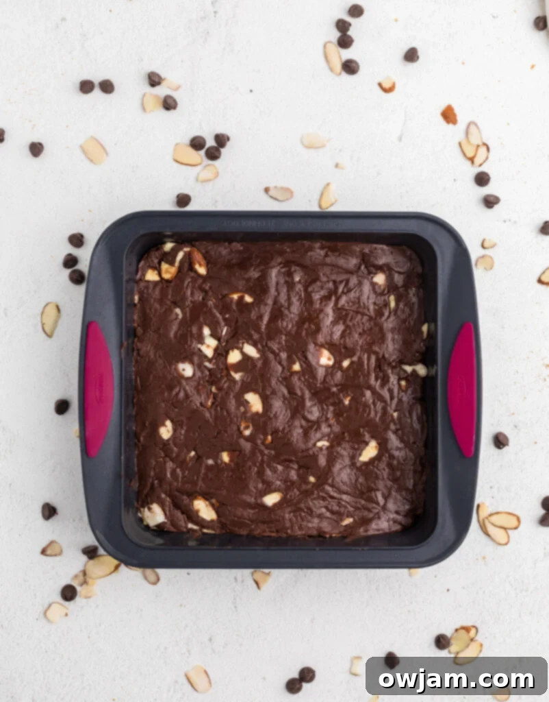 Easy Chocolate Fudge setting in a pan inside the refrigerator.