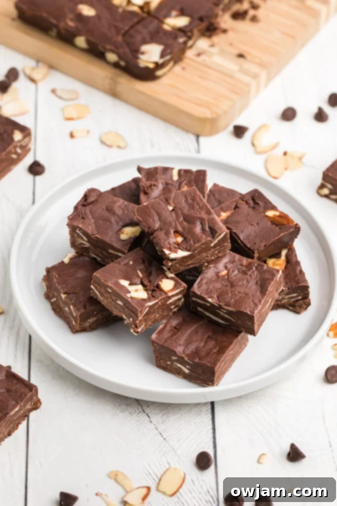 Easy Chocolate Fudge squares cooling on a cutting board, ready for enjoyment.