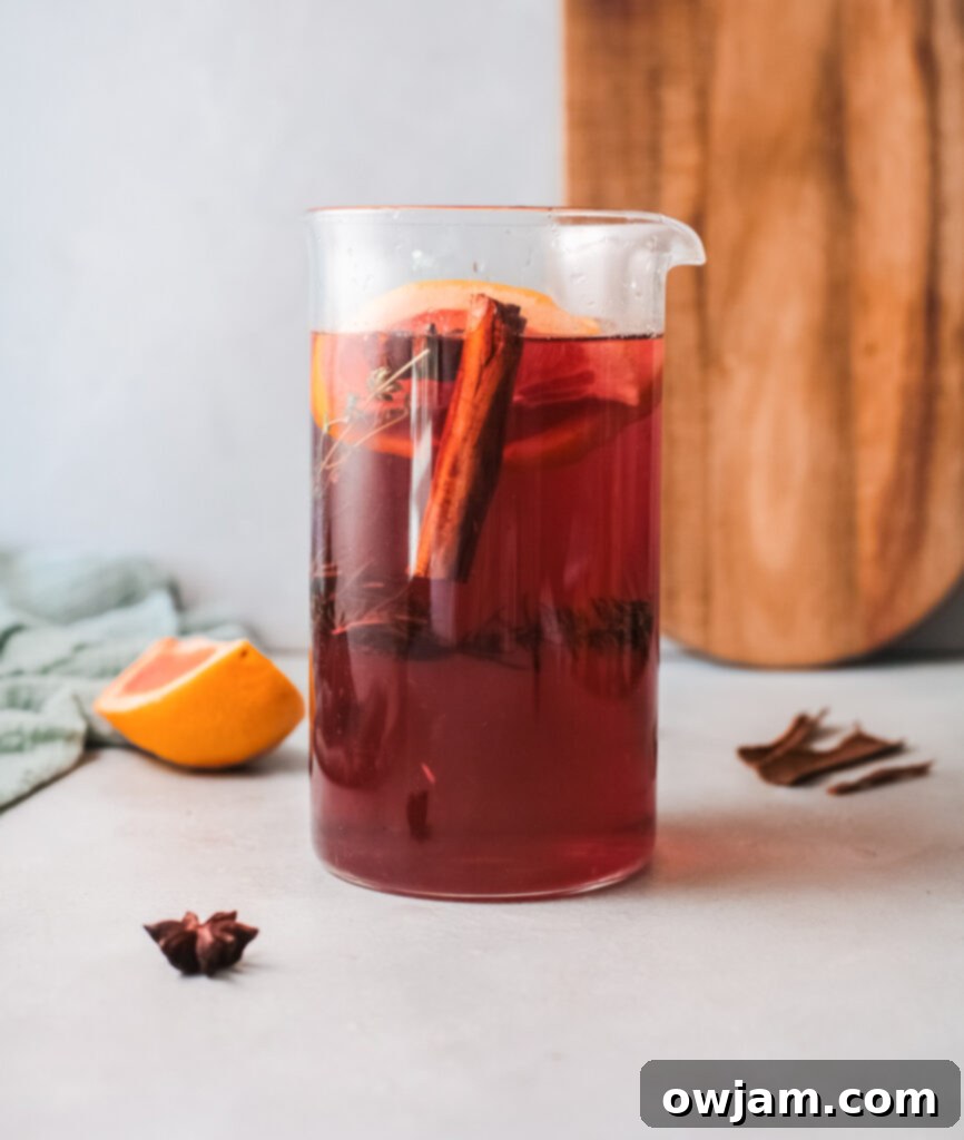 Cranberry Blush Sparkler 4 Large pitcher filled with Cranberry Wine Spritzer, garnished with fresh blood orange slices, ready for serving.