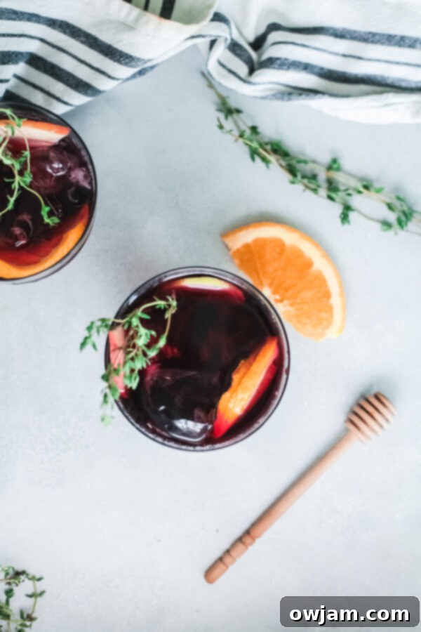 Your New Favorite Red Sangria 8 Serving glasses of red sangria, garnished with fresh rosemary