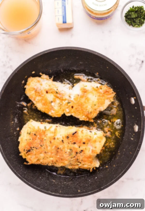 Pan Fried Garlic Butter Cod browned in skillet 