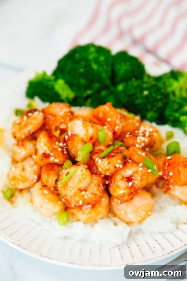 Honey Garlic Sriracha Shrimp with steamed broccoli on a plate, ready to be served as a healthy meal.