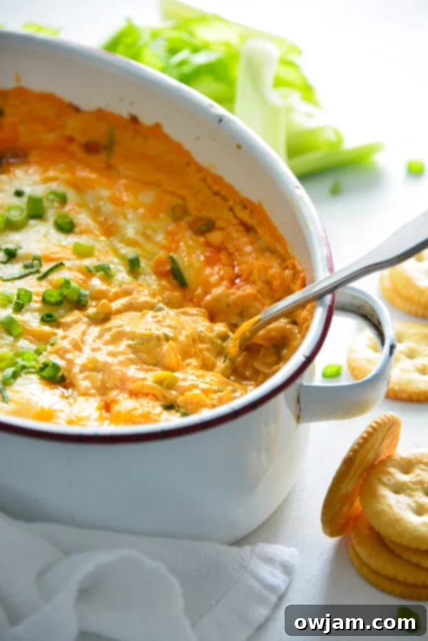 The Ultimate Buffalo Chicken Dip 5 Mixing the creamy base for Buffalo Chicken Dip in a large bowl