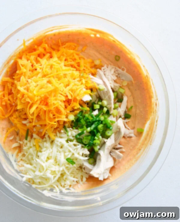 The Ultimate Buffalo Chicken Dip 8 All ingredients for Buffalo Chicken Dip mixed together in a large bowl, ready for baking