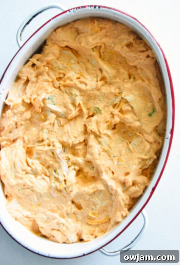The Ultimate Buffalo Chicken Dip 9 Buffalo Chicken Dip mixture neatly spread into a white rectangular baking dish