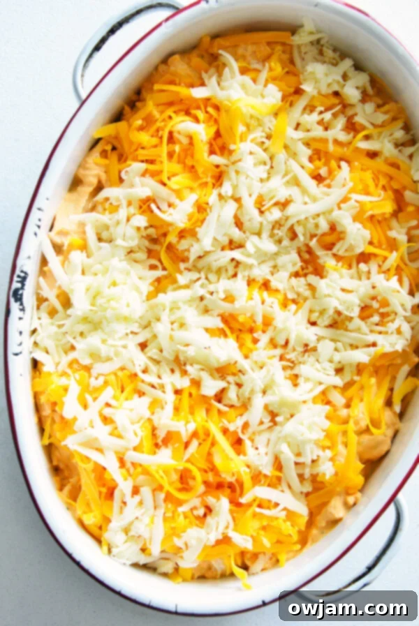 The Ultimate Buffalo Chicken Dip 10 Buffalo Chicken Dip generously topped with shredded cheese before baking