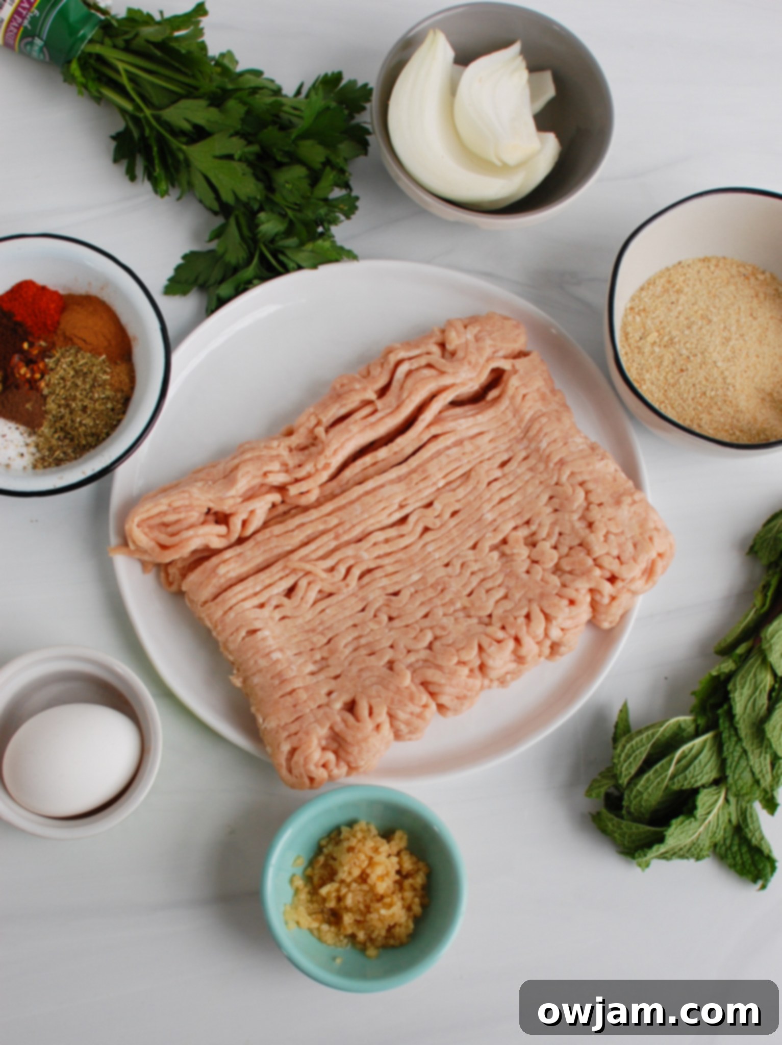 Chicken Meatballs 4 Fresh ingredients laid out for making Chicken Kofta, including ground chicken, herbs, and spices.