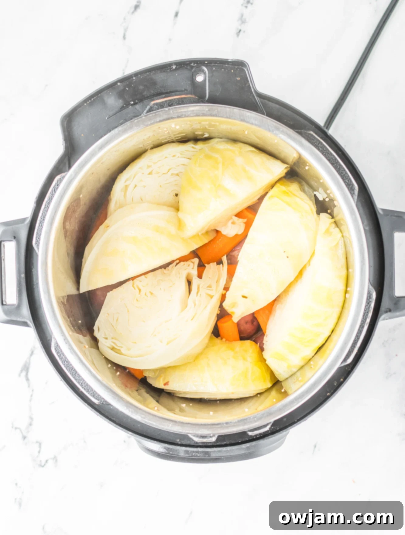 Tender Instant Pot Corned Beef and Cabbage 11 Potatoes, carrots, and cabbage added to the Instant Pot with broth