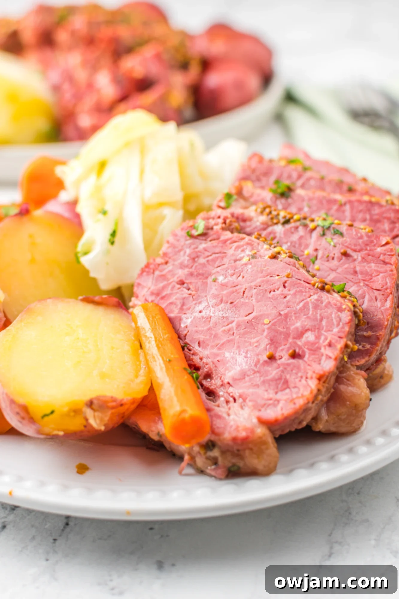 Tender Instant Pot Corned Beef and Cabbage 3 Close-up of Instant Pot Corned Beef and Cabbage on a white plate