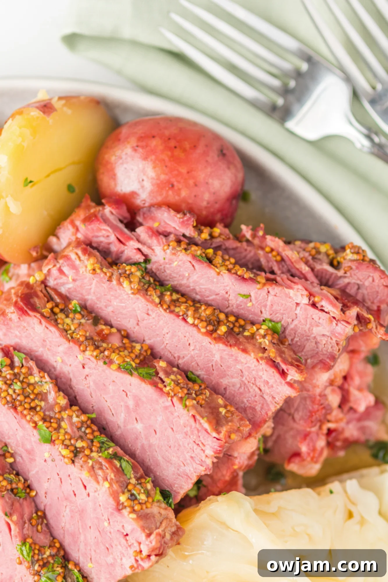 Tender Instant Pot Corned Beef and Cabbage 4 Instant Pot Corned Beef and Cabbage with a slice cut, on a white plate
