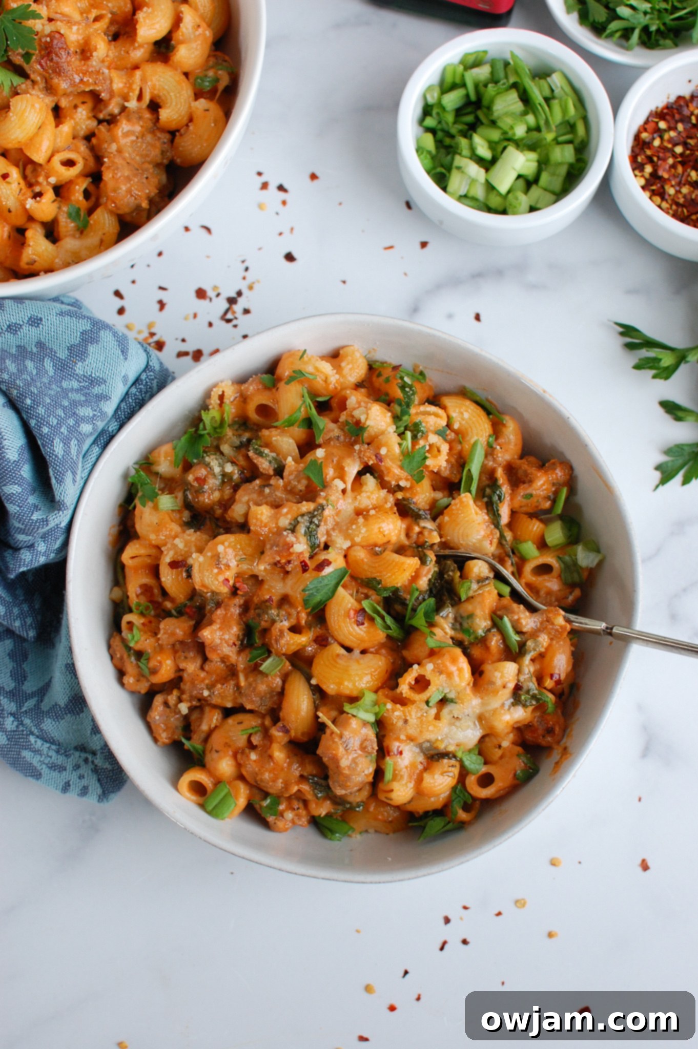 Sizzling Sausage Pasta 4 Spicy Sausage Pasta served in a white bowl