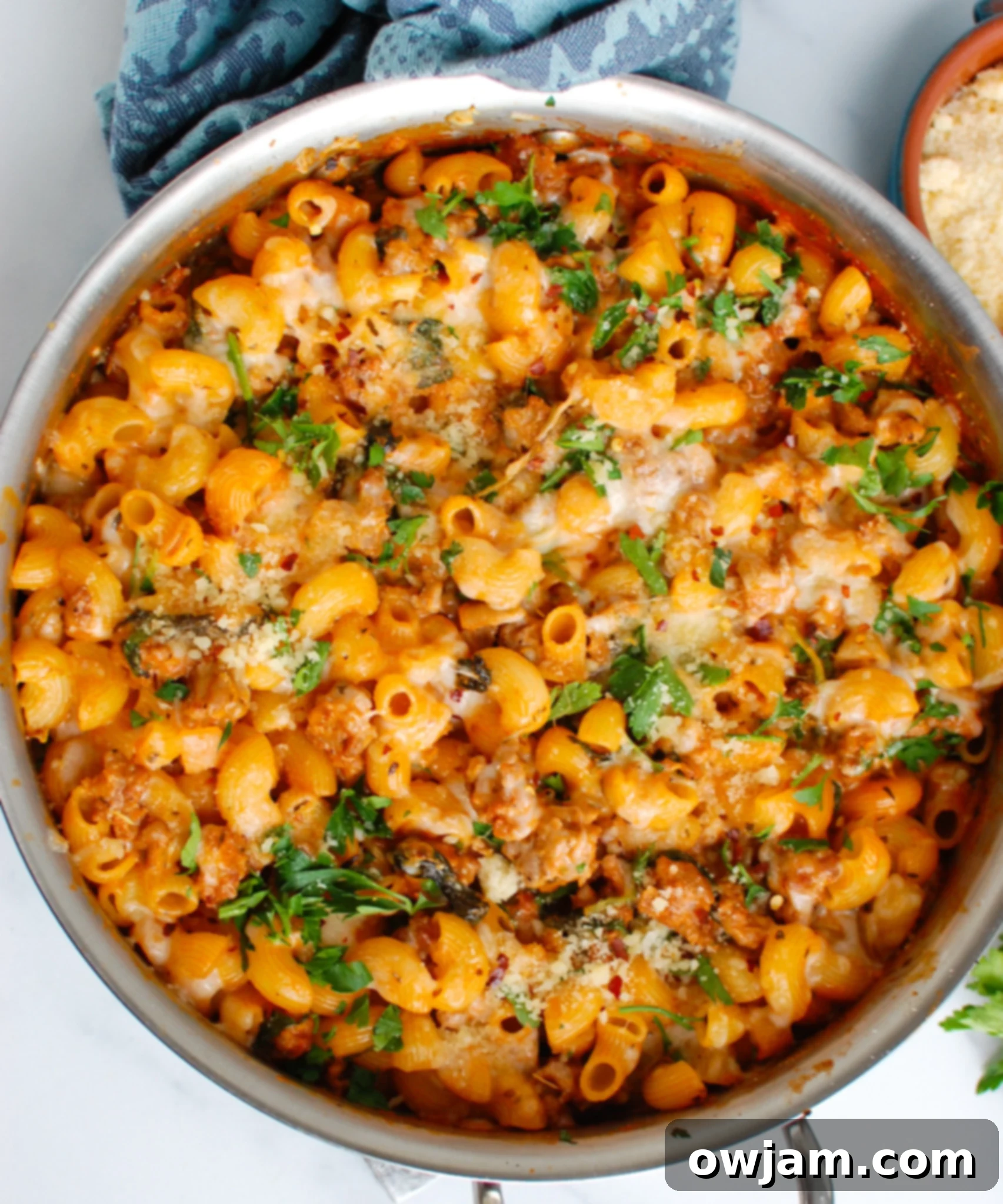 Sizzling Sausage Pasta 5 Spicy Sausage Pasta in a white bowl, garnished with fresh parsley