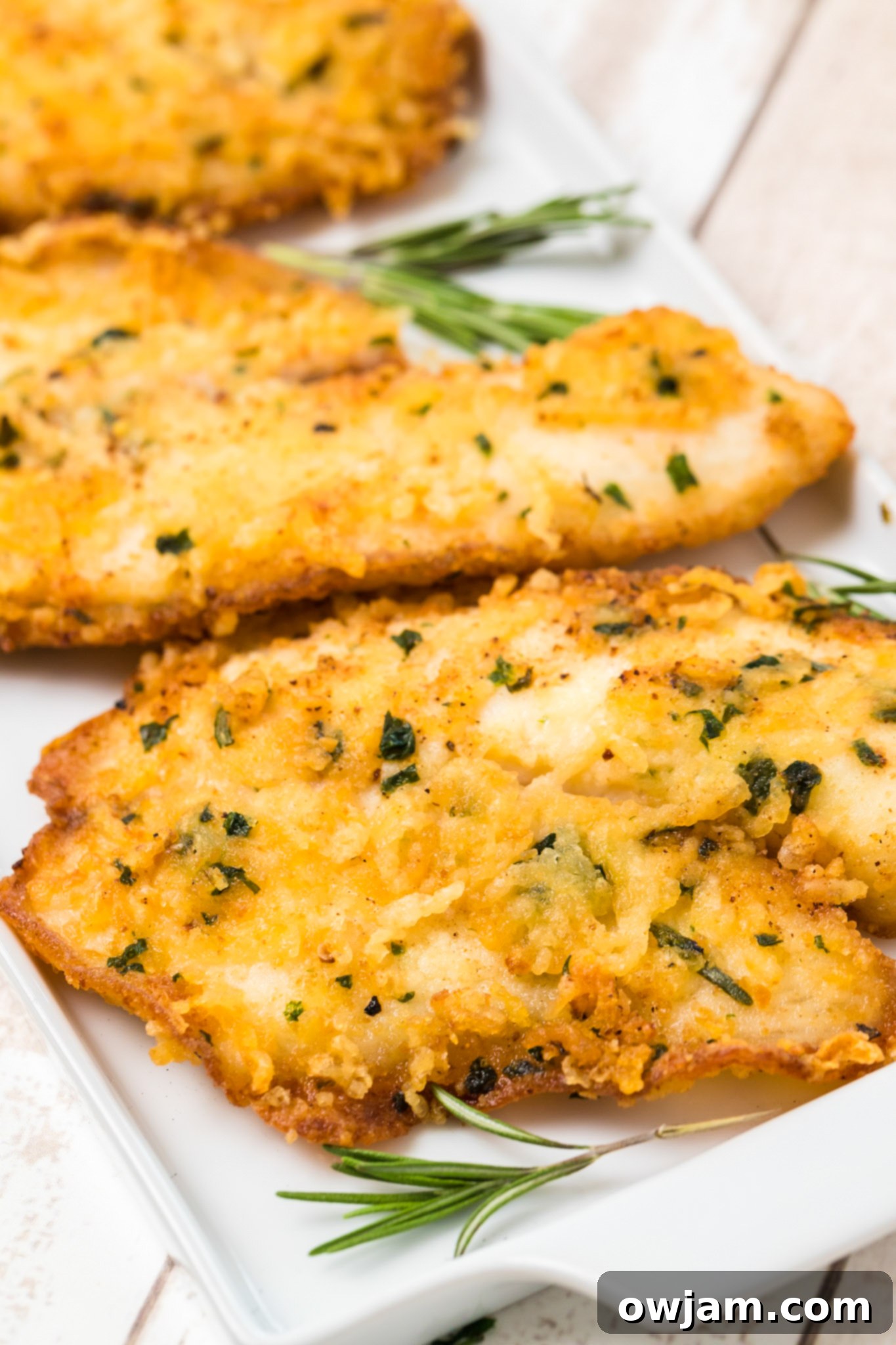 Crispy Parmesan Tilapia 4 Fresh parsley and rosemary for Parmesan Crusted Tilapia, showing the aromatic herbs ready for cooking.