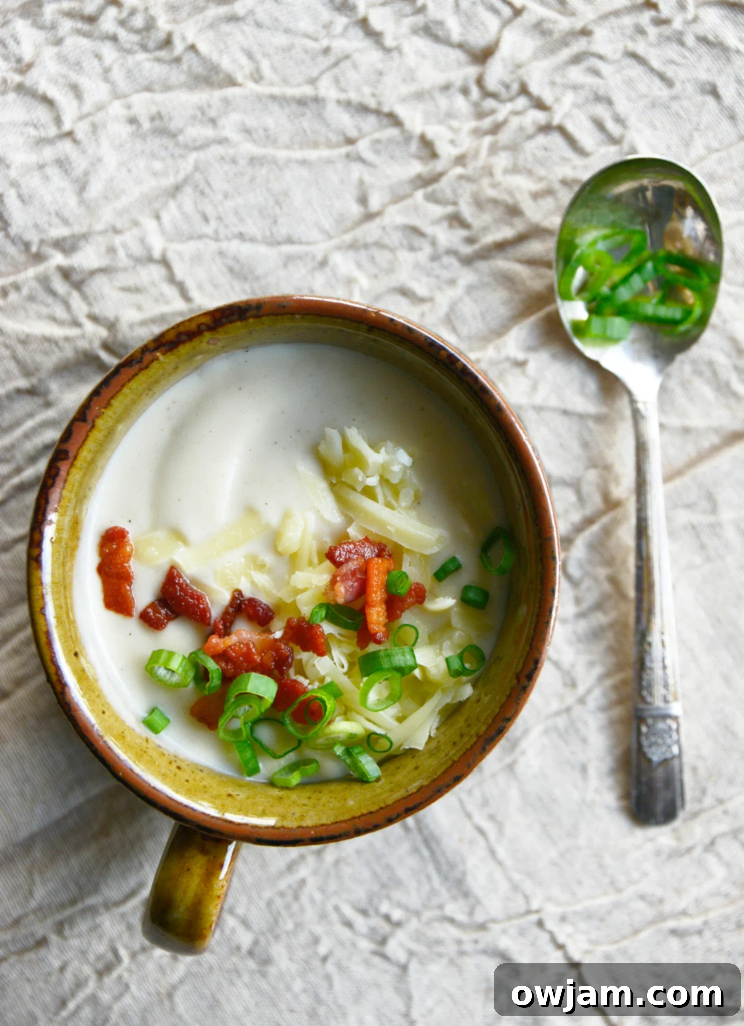Instant Pot Cauliflower Soup with green onions on the soup.