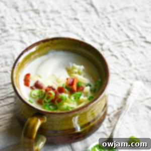 Instant Pot Cauliflower Soup in a bowl with a spoon.