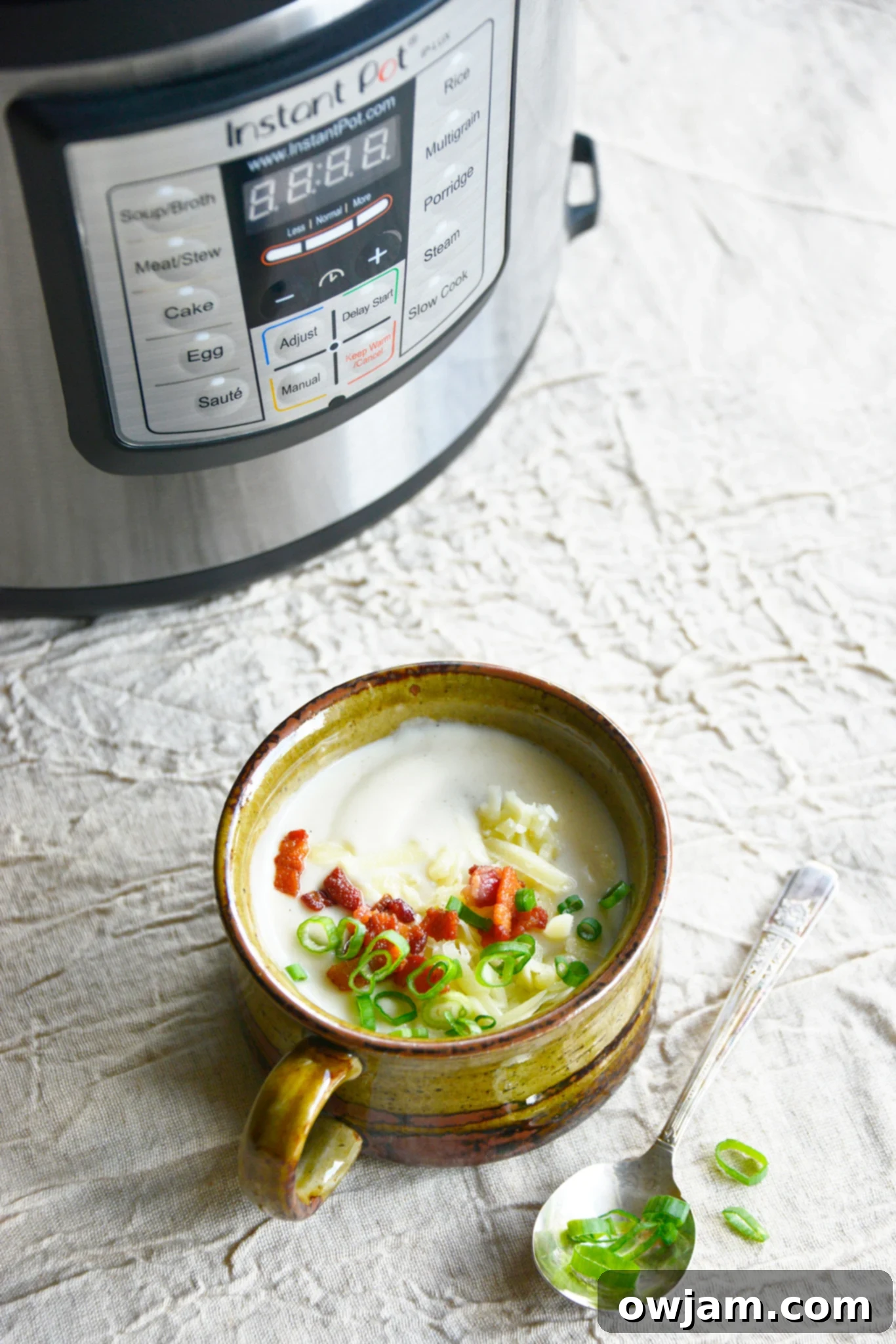 Instant Pot Cauliflower Soup with Instant Pot in background. 