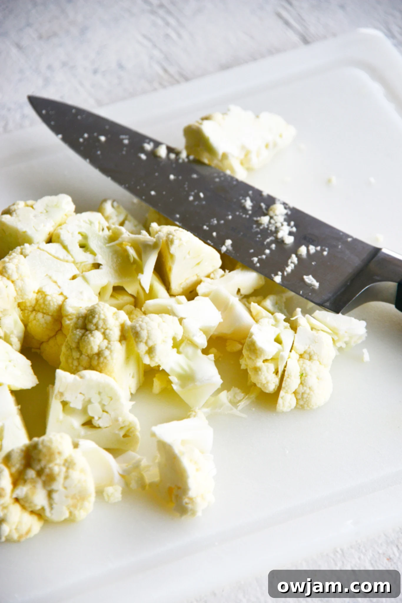 Instant Pot Cauliflower Soup cauliflower with a knife.