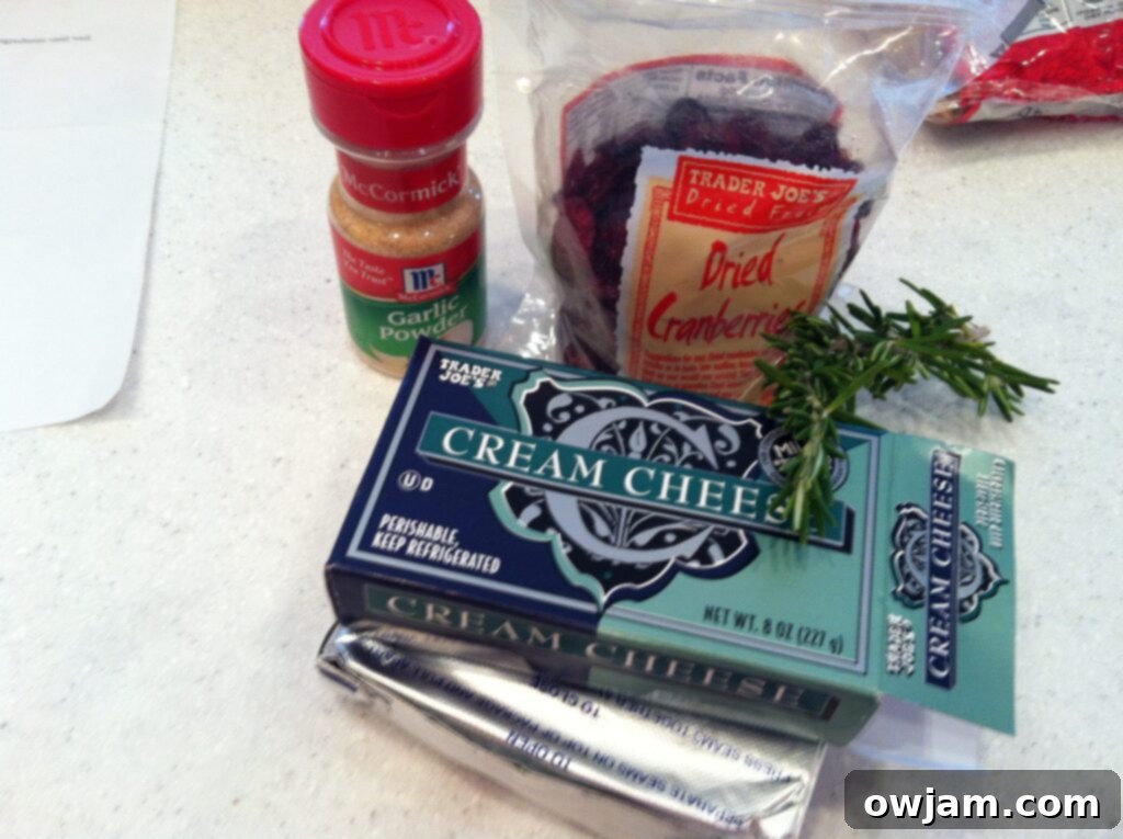 Ingredients for homemade Rosemary Cranberry Spread: cream cheese, fresh rosemary, dried cranberries, garlic powder