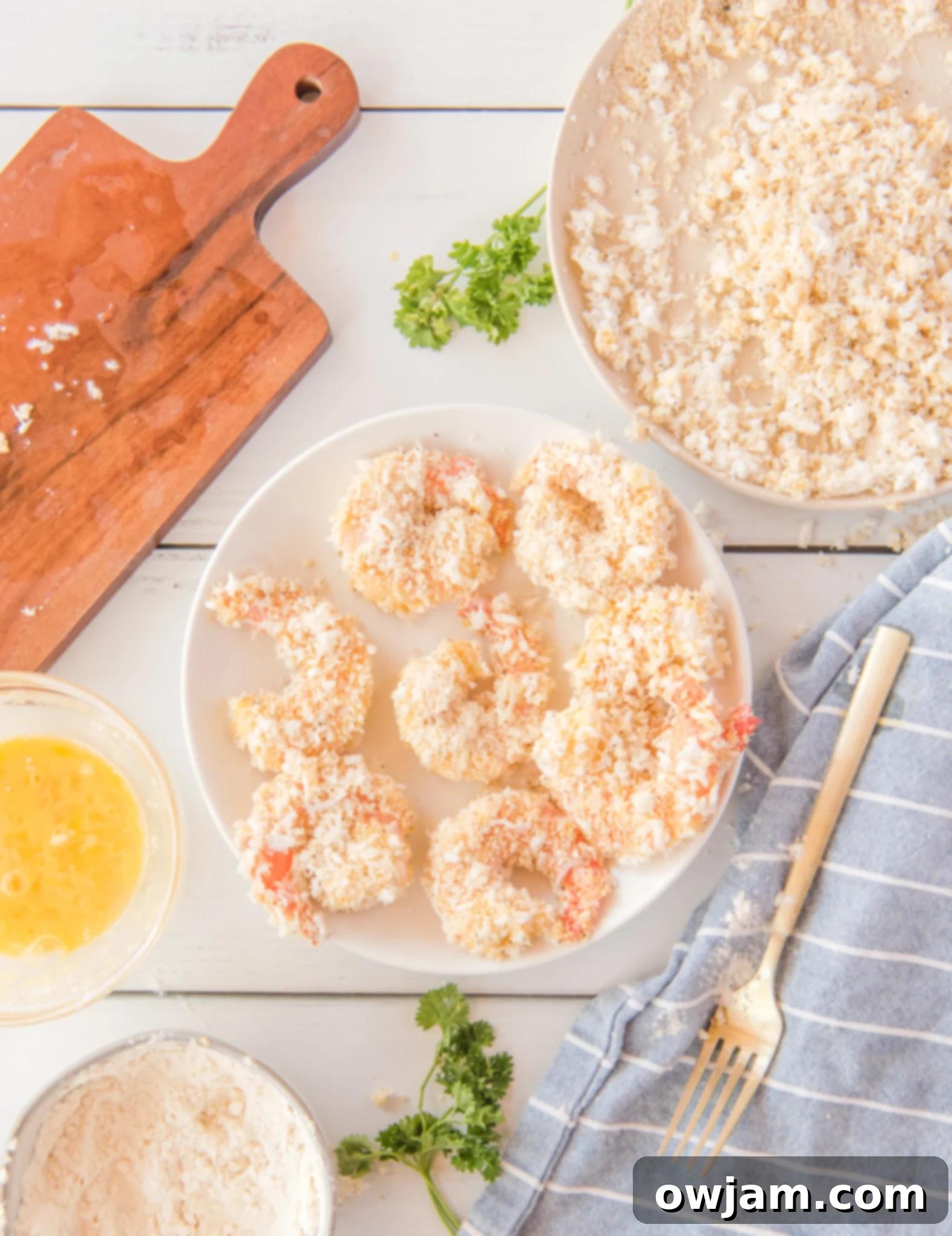 Golden Air Fryer Coconut Shrimp 11 Air Fryer Coconut Shrimp with the shrimp on a plate ready to air fry.