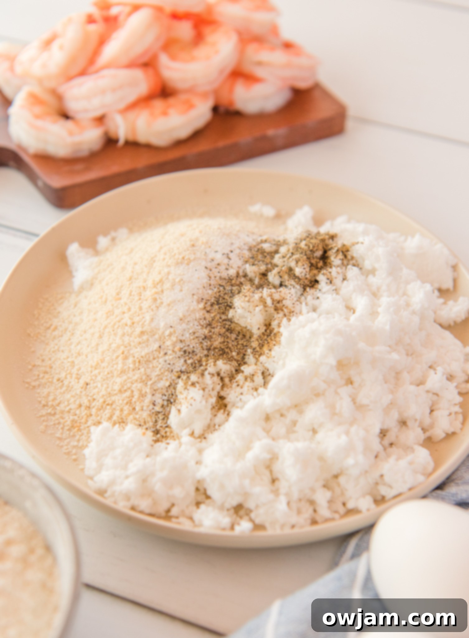 Golden Air Fryer Coconut Shrimp 5 Air Fryer Coconut Shrimp ingredients in a bowl.