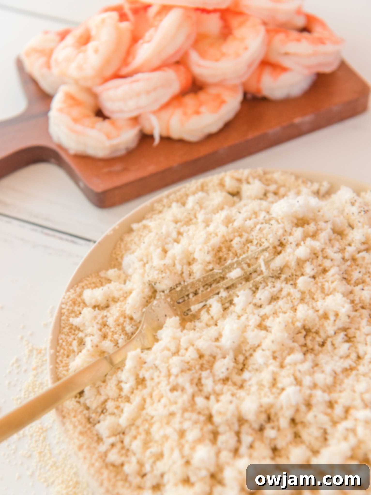 Golden Air Fryer Coconut Shrimp 6 Air Fryer Coconut Shrimp with fork in a bowl.