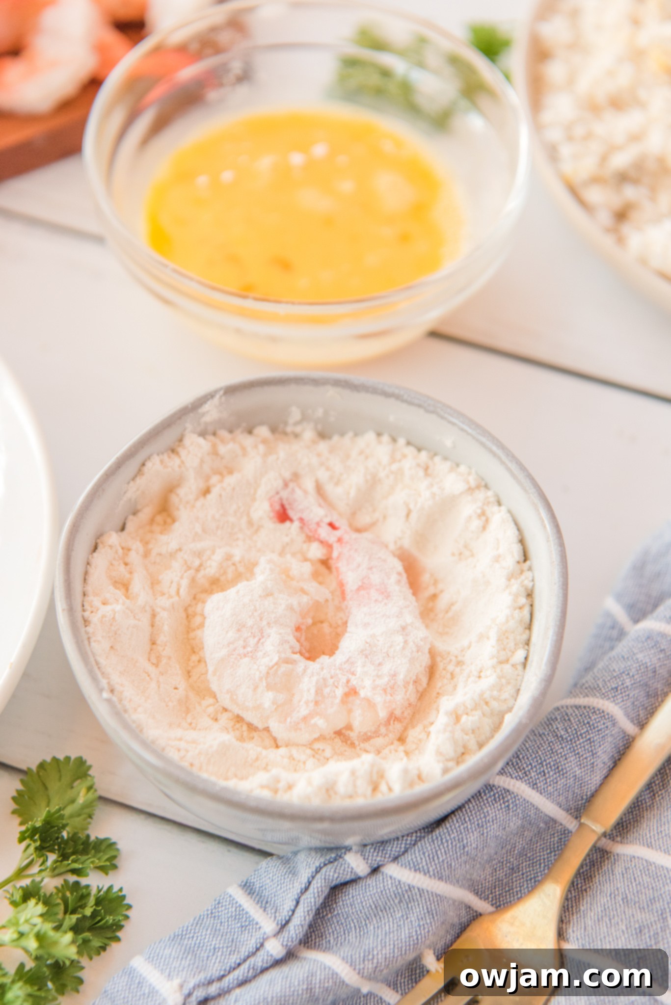 Golden Air Fryer Coconut Shrimp 7 Air Fryer Coconut Shrimp with the shrimp in the flour.