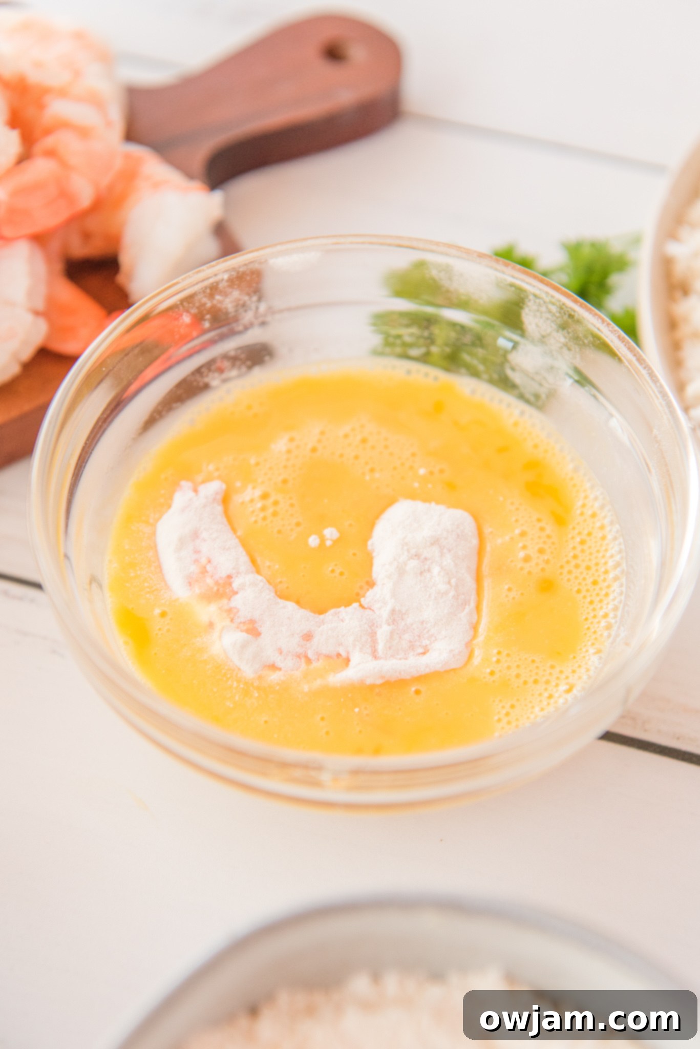 Golden Air Fryer Coconut Shrimp 8 Air Fryer Coconut Shrimp in egg.