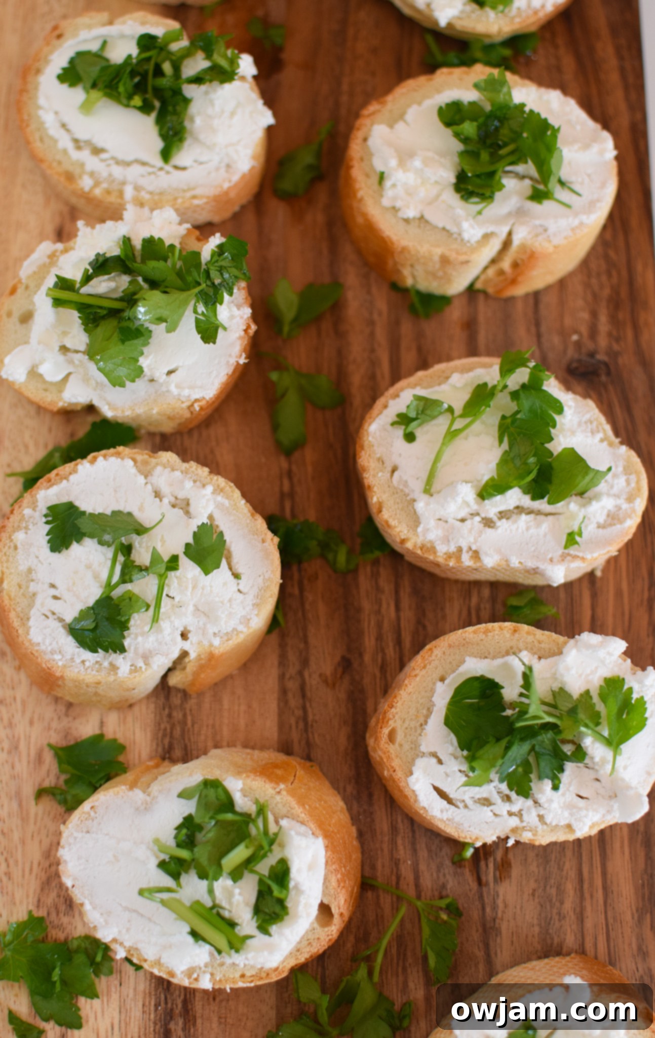 Caramelized Onion Beef Bites 7 Fresh parsley being added to whipped goat cheese for Beef Crostini with Caramelized Onion and Goat Cheese.