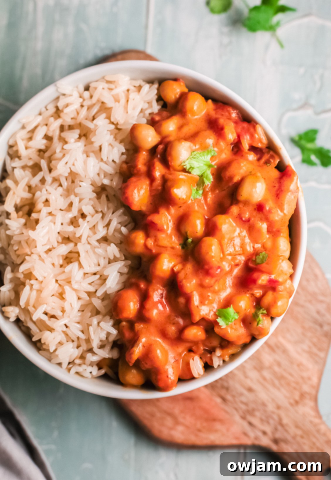 Chickpeas with Curry in a bowl, garnished with fresh parsley.