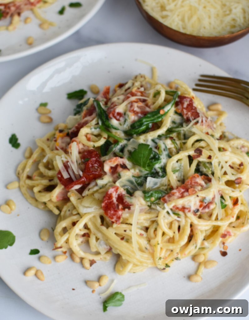 Creamy Sun-Dried Tomato Pasta 4 Creamy Sun Dried Tomato Pasta Recipe served on a white plate, garnished with fresh herbs and Parmesan.
