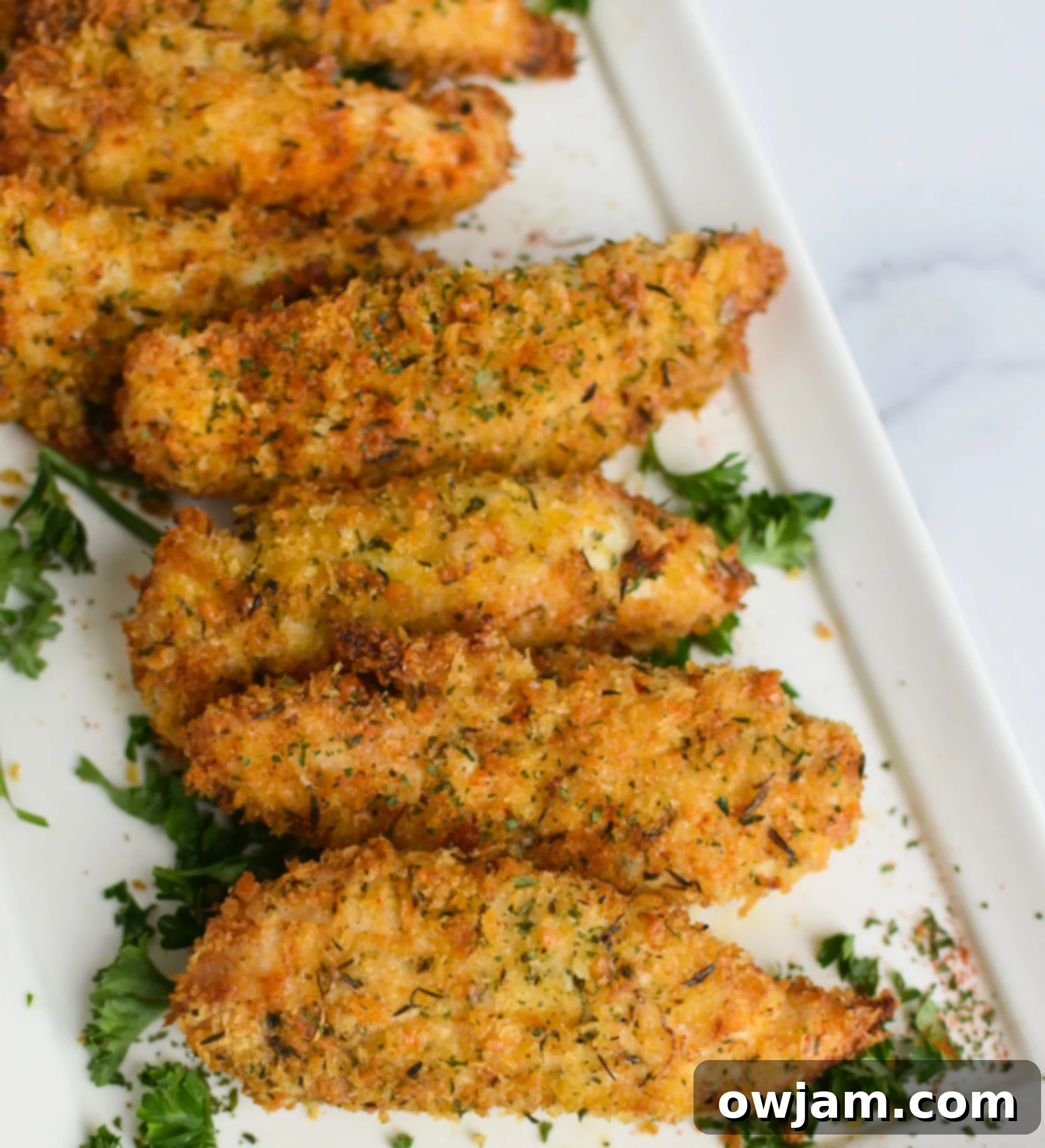 Crispy Air Fryer Chicken Tenders 2 Crispy Air Fryer Chicken Tenders served on a white plate with dipping sauce