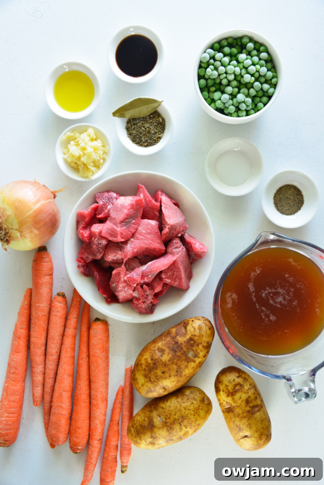 Easy Instant Pot Beef Stew 3 Instant Pot Beef Stew Recipe ingredients laid out on a board, showcasing fresh beef, vegetables, and spices.