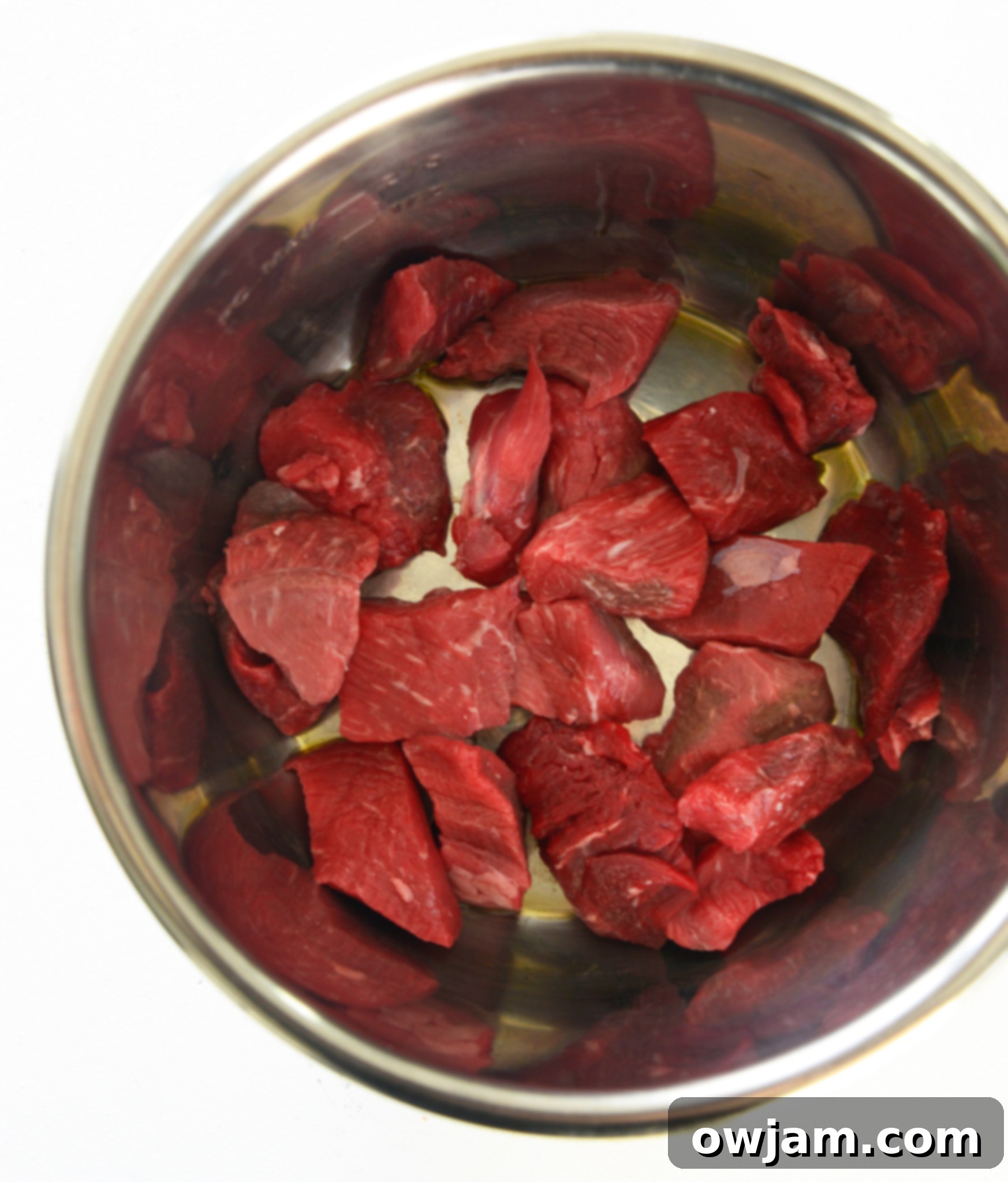 Easy Instant Pot Beef Stew 5 Instant Pot Beef Stew Recipe with beef searing in the Instant Pot, showing the browning process.