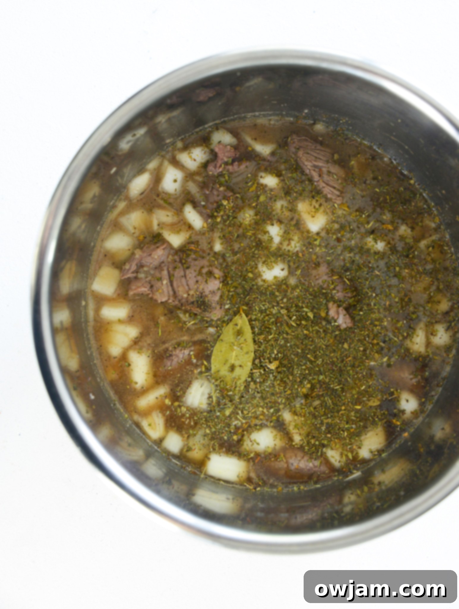 Easy Instant Pot Beef Stew 7 Instant Pot Beef Stew Recipe being served with a ladle, showing the rich texture.
