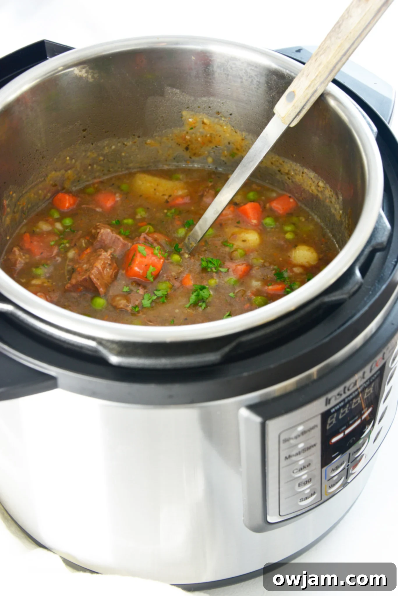Easy Instant Pot Beef Stew 9 Instant Pot Beef Stew Recipe cooking in the pressure cooker, showing the lid on.