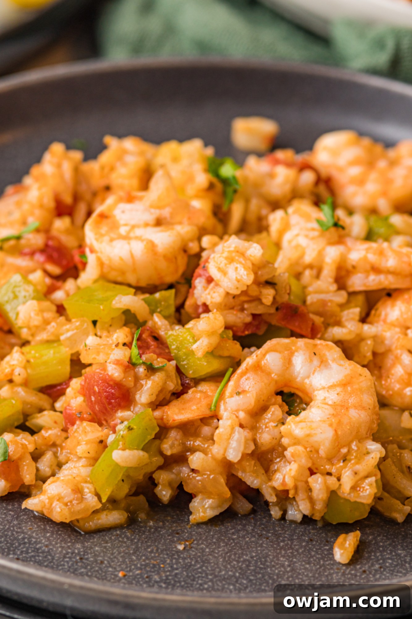 Cooked Shrimp Creole served in a foil packet on a black plate.
