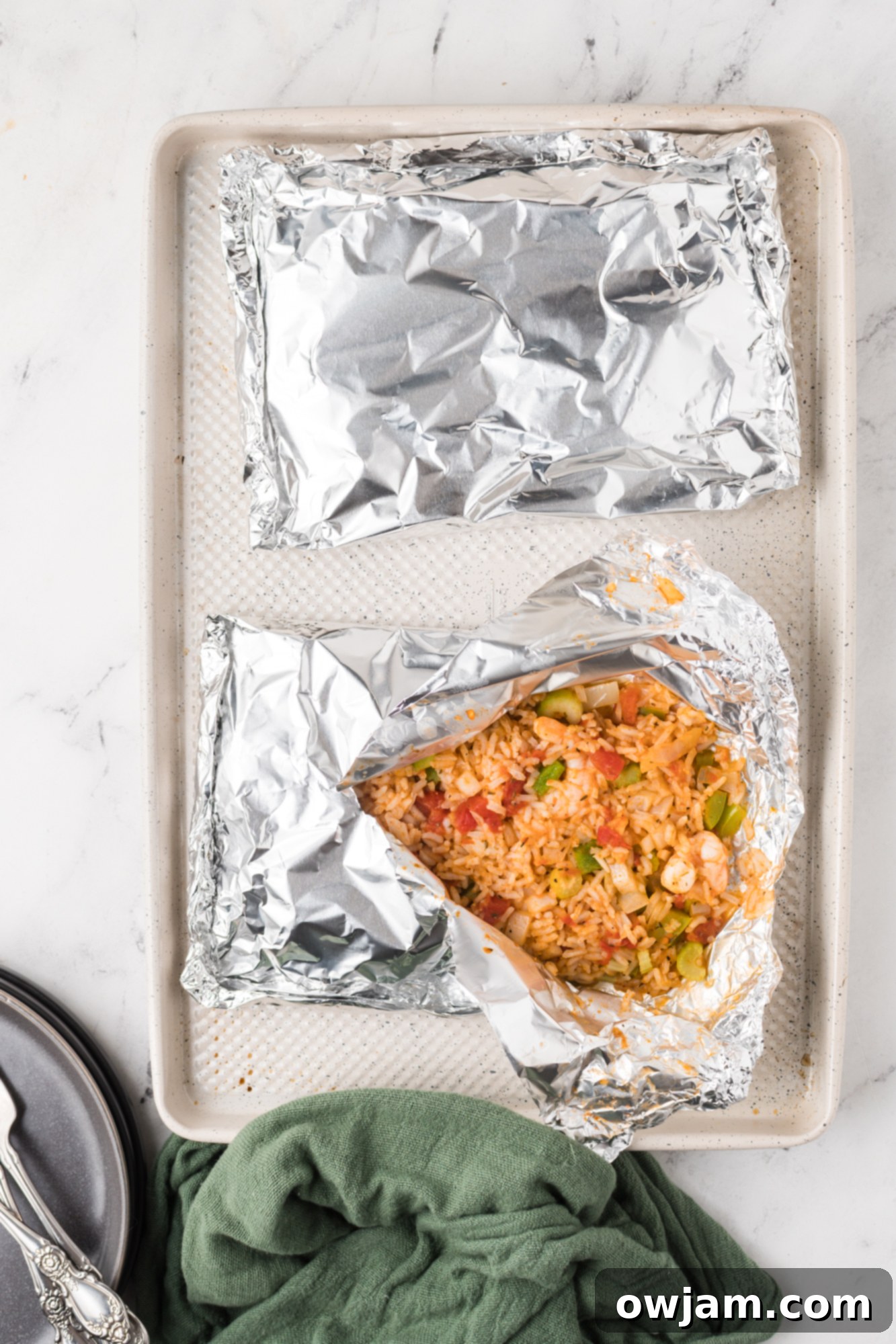 Shrimp Creole Recipe foil packet on a baking sheet.