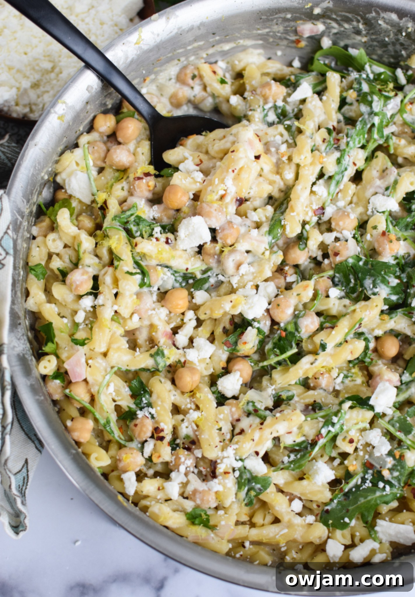 Mediterranean Chickpea Pasta with Feta 4 Chickpea Pasta Recipe with Feta simmering in a large pot, showing the creamy sauce and ingredients.