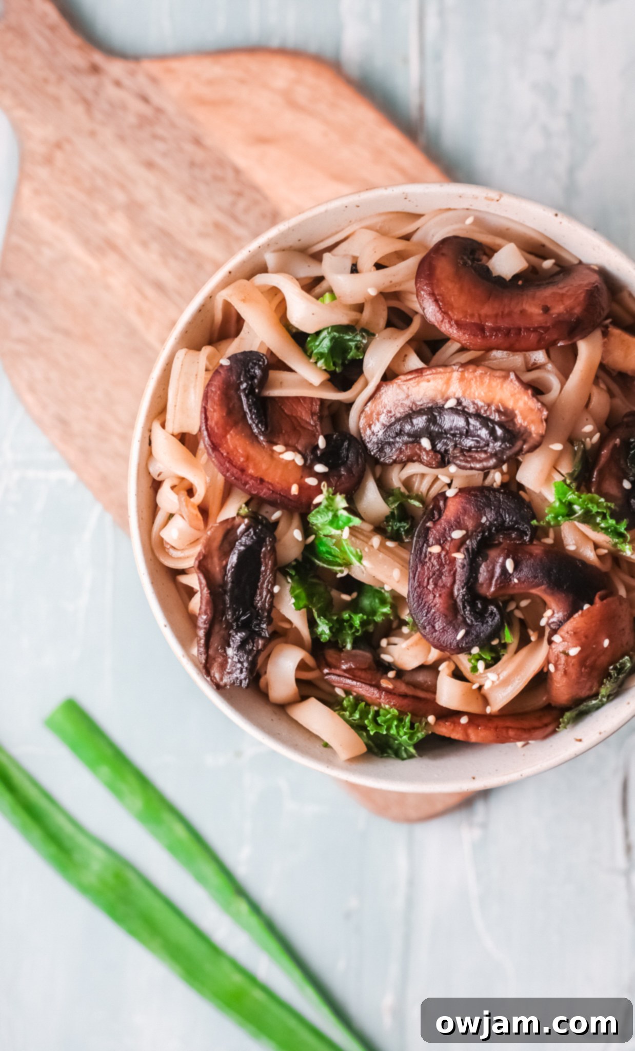 Delicious Korean Noodles in Minutes 11 Easy Korean Noodles Recipe served in a bowl, garnished with green onions and sesame seeds.